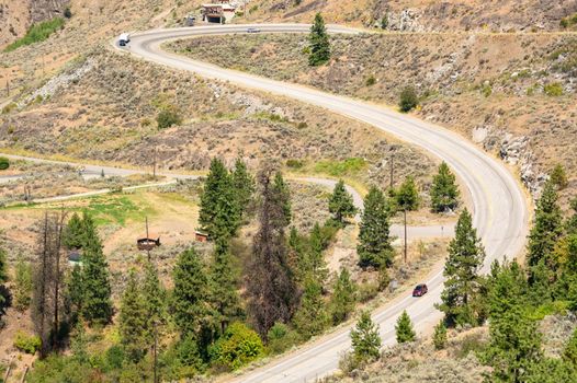 S-curved road in Rocky mountains on summer day