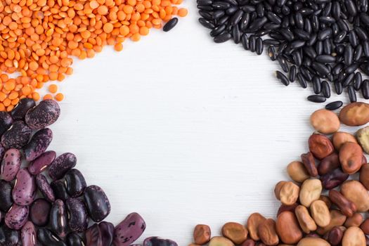 Multicolored background of organic vegan vegetarian grain food cereal bean lentils ingredients mix with copy-space