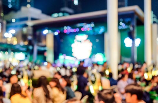 Blurred view on night scene of people at the beer garden and the singer's mini concert will bring happiness to the people who come to celebrate the festival countdown to the New Year