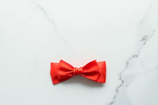 Holiday decor, feminine design and flatlay concept - Red silk ribbon on marble, top view