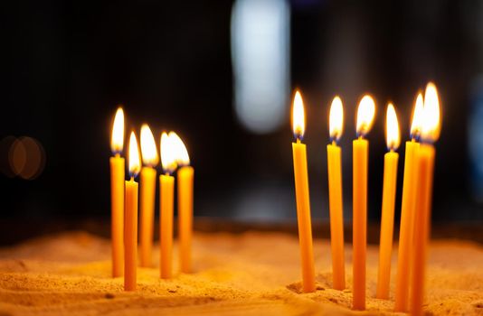 burning candles during a ceremony in a church.