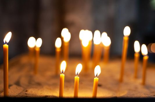 burning candles during a ceremony in a church.