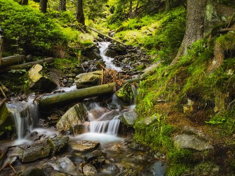 Small stony waterfall next to mountain trail in Giant Mountains