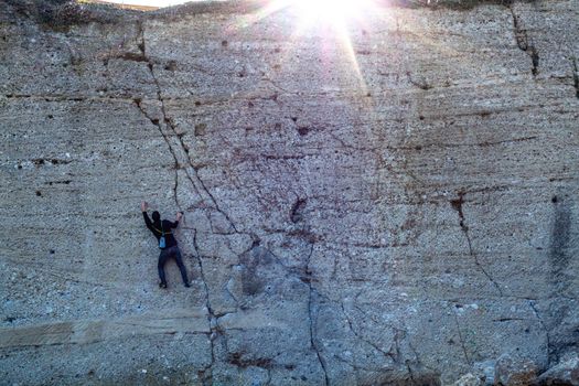 a climber climbs a mountain on a stone cliff.