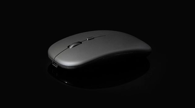 wireless black mouse isolated on black background with clipping path