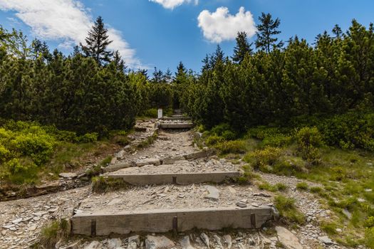 Long mountain trail full of stony stairs with panorama if Karkonosze Giant Mountains around