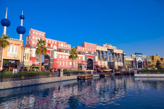 DUBAI, UAE - DECEMBER 16 2020 Beautiful view of the Iran pavilion and Canal with pleasure boats in the park entertainment center captured in the evening time at The Global Village , Dubai,UAE.