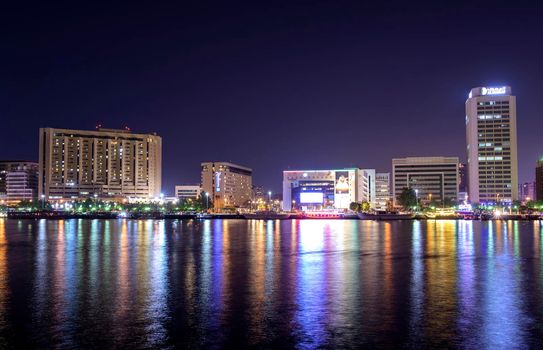 Dec 17 2020, Al seef village, Dubai. Panoramic view of the illuminated sky scrappers,hotels and buildings showing beautiful reflections in water captured at the Al Seef, Dubai ,UAE.