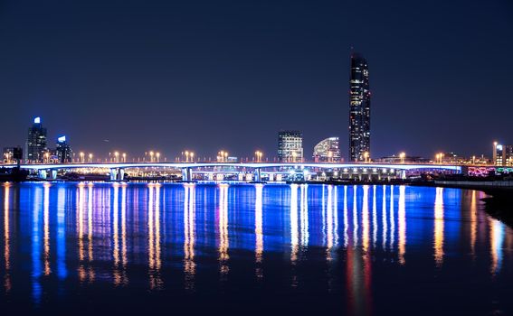 Dec 29th 2020. Beautiful night view of the illuminated Garhoud bridge across the water with reflections, surrounded by the majestic sky scrapers and hotels captured from the creek park Dubai , UAE.