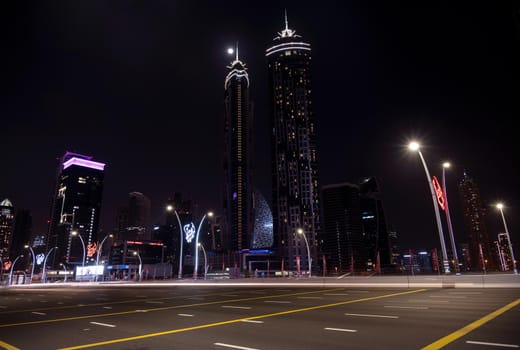 1ST jan 2021, Dubai , UAE.Moving traffic on the busy road with JW Marriott hotel and other sky scrappers in the background on a moonlit night captured at Dubai, UAE.