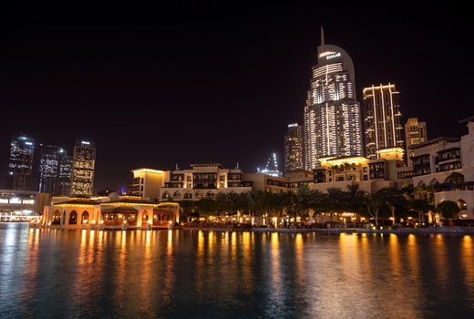 7th JAN 2021,Dubai,UAE . Beautiful view of the illuminated souk al bahar ,the dubai mall, hotels and other buildings captured at the recreational boulevard area of the Burj park , Dubai,UAE.