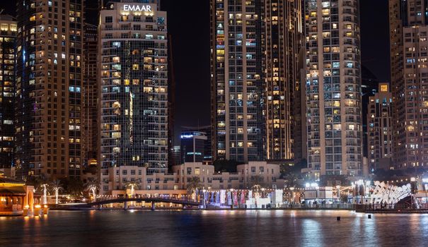 JAN 7th 2021,DUBAI, UAE. Beautifully illuminated decorations for the Dubai shopping festival at the busy recreational etisalat dsf market at the burj park with residential apartments in the background