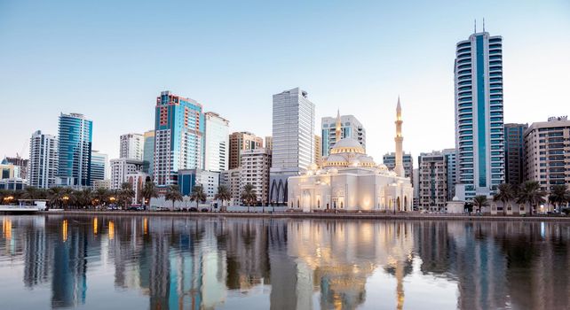 Jan 8th 2021, Sharjah, UAE. Panoramic view of the beautifully illuminated Al Noor mosque during the early sunrise hours showing reflections in water captured from the Al Noor island Sharjah, UAE.