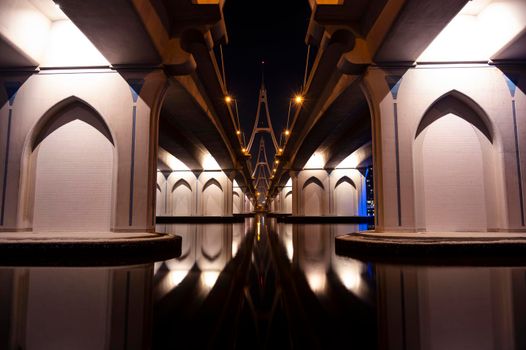 The beautifully illuminated business bay bridge, showing reflections on water captured from Al Jadaf waterfront, Dubai,UAE.