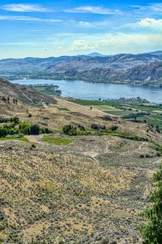 Scenic view of the landscape with a lake and mountains on sunny summer day.