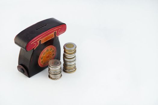 A money box with coins is isolated on a white background with a place for an inscription. High quality photo