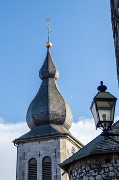 View at the tower of church Saint Lucia and street lamp in Stolberg, Eifel, Germany