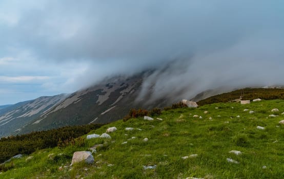 Clouds falling down to Sniezka mountain in Karkonosze Giant Mountains