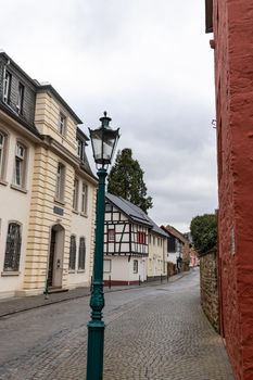 View at paved narrow road with historic buildings and street lamp in Bad Muenstereifel, Germany