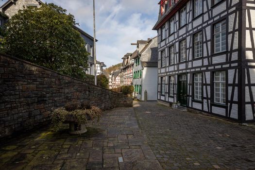 Paved narrow road with half-timbered houses in Monschau, Eifel, Germany