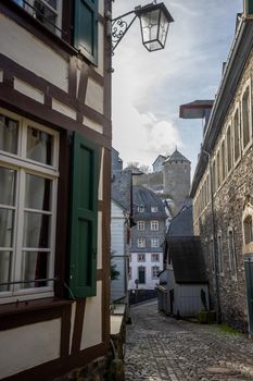 Paved narrow road with half-timbered houses in Monschau, Eifel, Germany