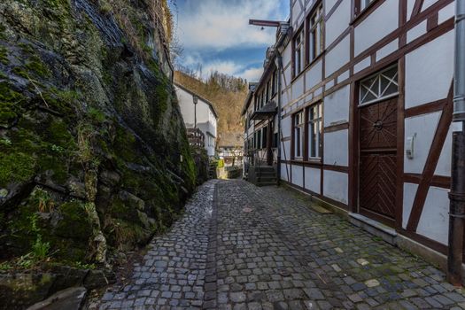 Paved narrow road with half-timbered houses in Monschau, Eifel, Germany