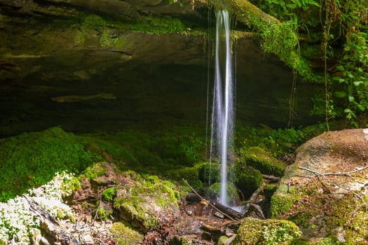 Water flowing over moss covered rocks in the canyon  Hexenklamm