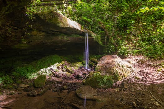 Water flowing over moss covered rocks in the canyon  Hexenklamm