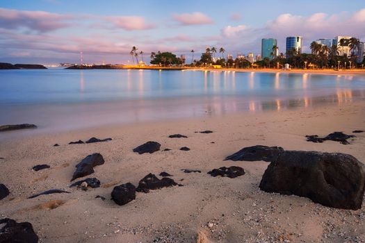 sunset over Magic Island Lagoon at Ala Moana Beach Park and Honolulu skyline, Honolulu, Oahu, Hawaii, USA