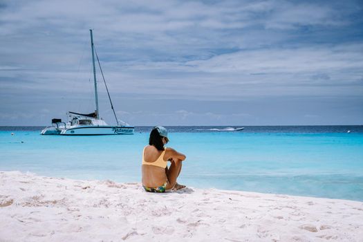 Small Curacao Island famous for day trips and snorkeling tours on white beaches blue clear ocean, Curacao Island in the Caribbean sea. woman on the beach during a vacation holiday