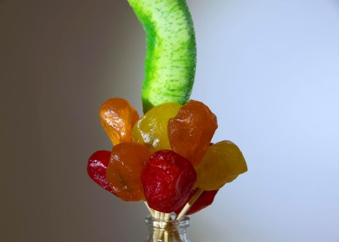 Bright green candied pomelo and dried kumquat yellow-red close-up. Dried fruits.