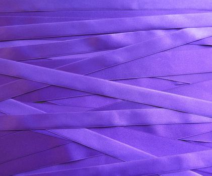 purple satin ribbons in a messy mess texture background