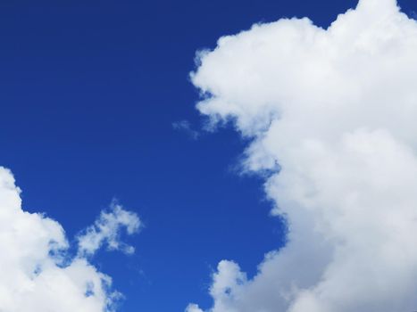 white fluffy clouds closeup in the blue sky