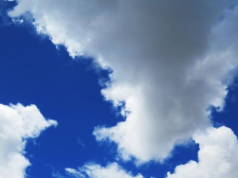 white fluffy clouds closeup in the blue sky