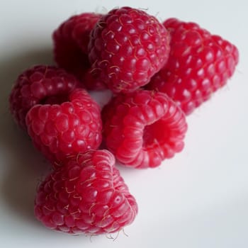 beautiful ripe raspberries on white background