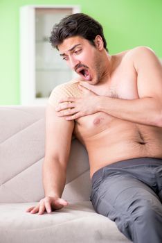 Man applying pepper Capsicum plaster to relieve pain