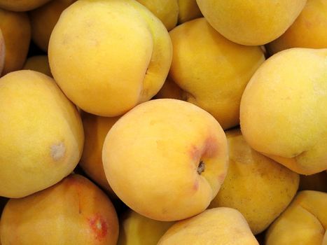 Ripe fresh peaches as background closeup