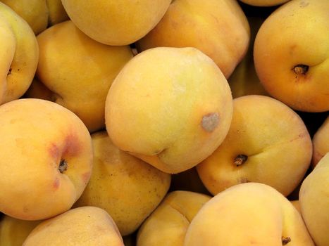 Ripe fresh peaches as background closeup