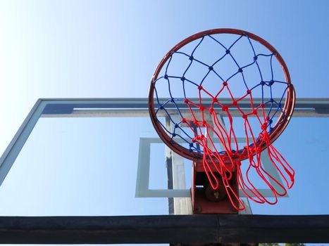 Basketball net on blue sky background