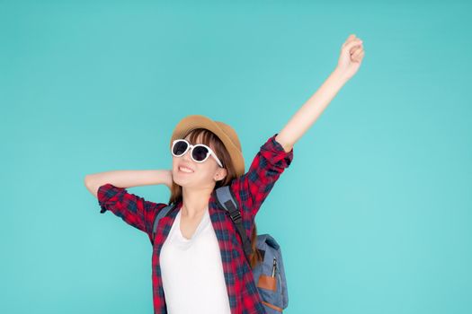 Beautiful portrait young asian woman wear sunglasses and hat smile excited and confident enjoy summer trip holiday isolated blue background, girl cheerful having backpack in vacation, travel concept.
