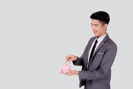 Young asian businessman in suit deposit money dollar with piggy bank isolated on white background, business man saving with planning budget and finance for success investment and financial.
