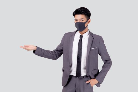Portrait young asian businessman in suit wearing face mask for protective covid-19 isolated on white background, business man presenting and showing, quarantine for pandemic coronavirus, new normal.