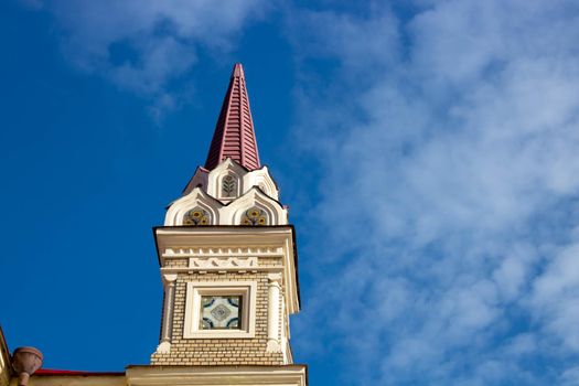 The tower in Rybinsk Russia on the museum building against the blue sky on a clear spring day.