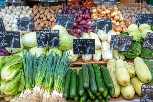 Big choice of vegetables and salad for sale at a market