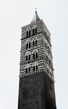 VITERBO-ITALY-August 2020-Bell tower of San Lorenzo cathedral ,built in Gothic style with alternating bands of white travertine and basalt stone and mullioned windows