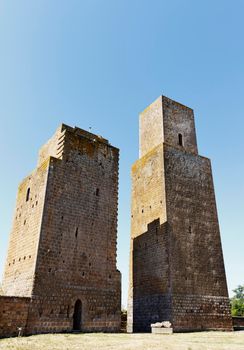 TUSCANIA -ITALY- August 2020 -two defense towers near San Pietro church in a bright sunny day