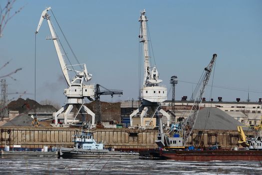 The river port. Water transport, a special cargo port crane and river sand mining. High quality photo