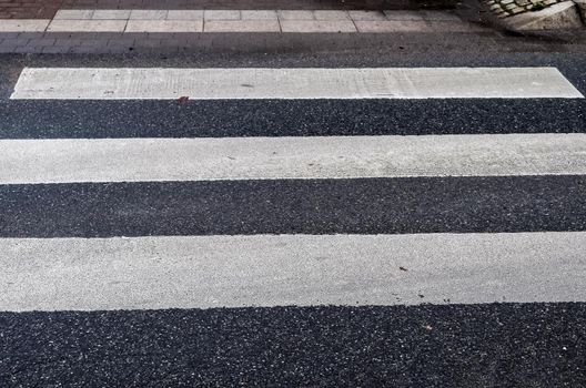 White painted pedestrian zebra crossing on a road in Europe