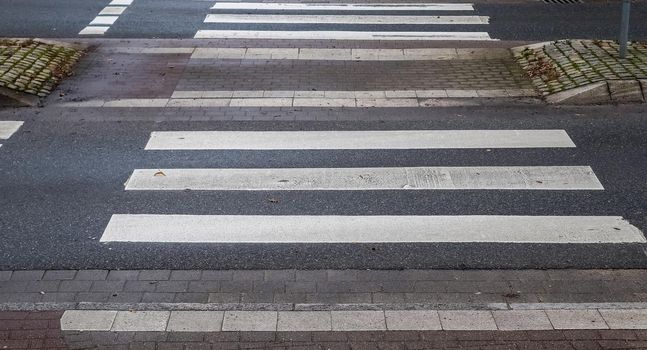 White painted pedestrian zebra crossing on a road in Europe