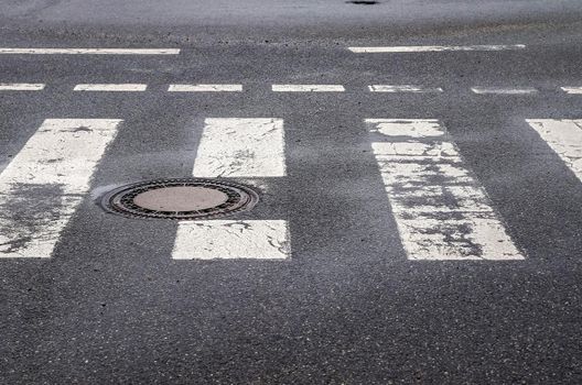 White painted pedestrian zebra crossing on a road in Europe